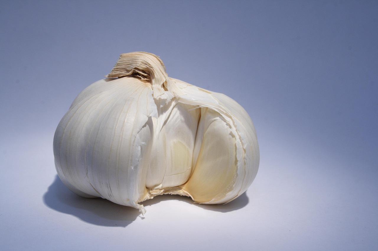 Aglio fresco su un tagliere, simbolo dei benefici per fegato e digestione.